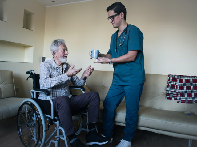 Male Home Caregiver is Helping a Senior Patient